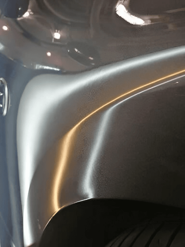 Same car door panel with the dent fully repaired