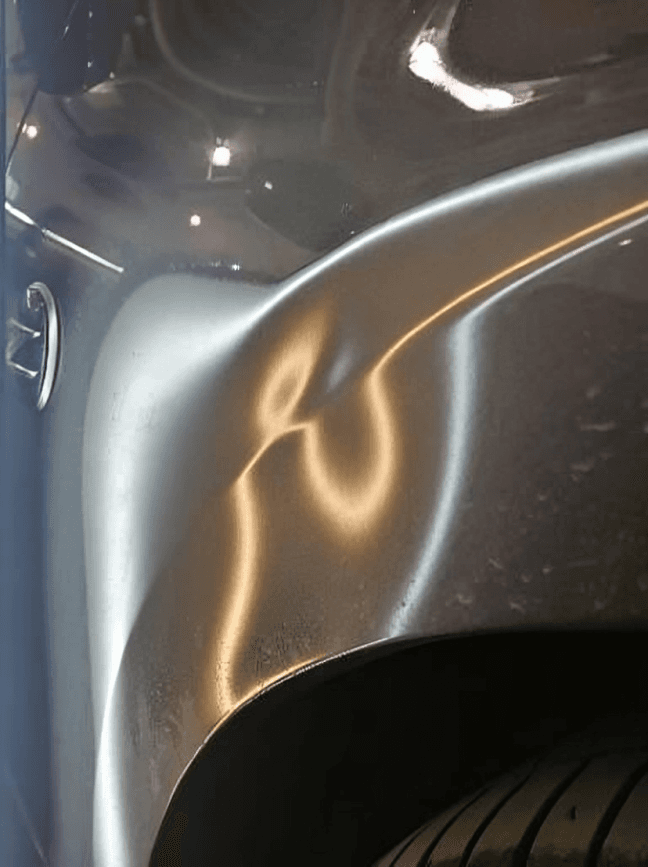 Vehicle door panel with a visible dent. Mobile PDR candidate